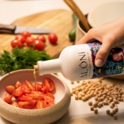 ALÓNI 'The Grove' Limited Edition EVOO bottle with collectible art by Greek artist Soteur shown next to its matching gift box