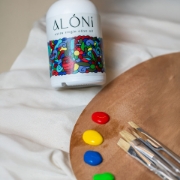 ALÓNI 'The Grove' Limited Edition EVOO bottle with collectible art by Greek artist Soteur shown next to its matching gift box