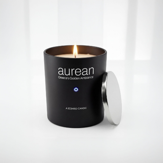Close-up of Aurean Nox Luxury Candle in a matte black jar with a silver lid and the Greek evil eye emblem, illuminated by a warm flame.