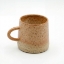 Handcrafted speckled ceramic coffee mug with rustic earth-tone glaze and ergonomic handle